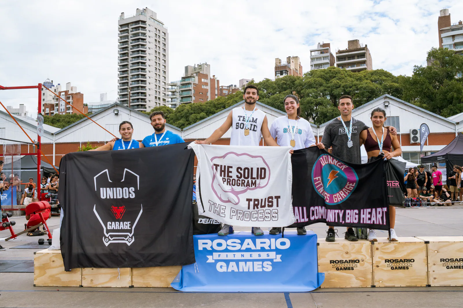 Equipos premiados con sus banderas en el podio de Rosario Fitness Games